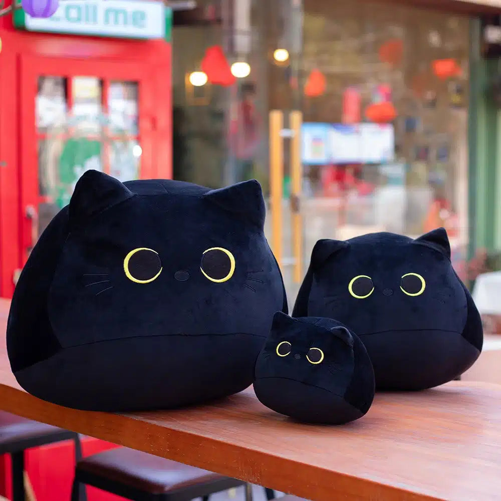 Peluche chaton noir aux grands yeux